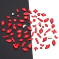 Close-up of assorted red glass rhinestones in heart, teardrop, and moon shapes - Bright Red - Irregular