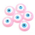 Detailed view of pink resin Evil Eye charms with black and blue iris and hanging hole - 30MM / Pink