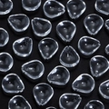Macro detail of transparent plum petal glass beads for DIY jewelry making and crafts - Clear Plum Petal