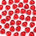 Close-up of vibrant red heart-shaped glass beads with center holes for DIY jewelry - 8mm (50 Pieces) / True Red