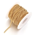 Detailed view of bulk gold plated stainless steel curb chain on white plastic spool - 1mm / Gold