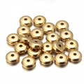 Close-up of golden CCB spacer beads with polished mirror finish for DIY jewelry - 4mm / Gold