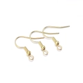 Close-up of three golden fishhook earring wires with spring and bead for DIY jewelry - 200pcs/pack / Gold