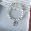 Close-up of pearl pet collar with blue enamel heart pendant on white velvet tray - XS Size (0.5-1.5kg) / Blue Rose