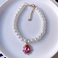Detail of pet pearl necklace with pink teardrop gemstone pendant and gold lobster clasp - XS / Rose Red