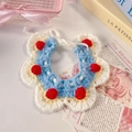 Detail view of handmade blue and white crochet pet collar with decorative red pom-poms - One Size / Snow White Scarf