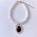 Elegant pet pearl necklace with a vintage black gemstone pendant and gold clasp details - XS / Black