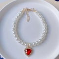Elegant white pearl pet necklace with a sparkling red heart pendant and gold lobster clasp - XS / Red