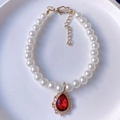Elegant pet necklace with white faux pearls and a red teardrop gem in golden finish - Red