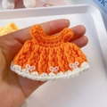 Detail of hand-crocheted orange 15cm doll dress with white bows and lace edges - Suitable For 15cm Doll / Orange
