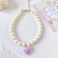 Detail of colorful pet necklace with white pearls and iridescent purple heart pendant - Creamy White Necklace