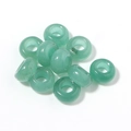 Macro view of translucent green donut beads with natural mineral texture for jewelry DIY - 10mm / Green Aventurine