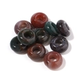 Close-up of polished natural stone donut beads with center hole for DIY jewelry - 10mm / Agate