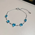 Elegant aquamarine cubic zirconia bracelet with heart and bow accents in silver finish. - #8 Bracelet - Silver - Blue