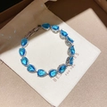Elegant silver-tone bracelet featuring teardrop-shaped blue zircons in a gift box setting. - Blue Pear Shape Inlaid Style