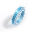 Close-up of light blue elastic beading thread wound on a clear plastic spool for jewelry - Blue