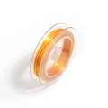 Close-up of orange elastic crystal string on transparent spool for DIY jewelry making - Gold