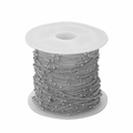 Close-up of 1.5mm silver metal bead satellite chain neatly wound on a white plastic spool - White K/Silver