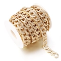 Flat golden aluminum curb chain with diamond cut texture on a white spool - Textured NK Chain Gold