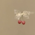 Close-up detail of a sweet white lace bow hair clip featuring cute pink cherry dangles - Cherry Bowknot Duckbill Clip / Single Piece / White and Pink