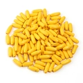 Macro shot of pile of yellow oval maple wood beads for DIY jewelry and necklace crafting - Yellow