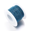 Roll of royal blue rhinestone trim with four-claw setting on a white plastic spool - Cyan Blue