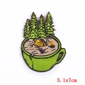 Detail of a green mug camping embroidery patch with tent and bonfire, size 5.1x7cm - Camping Mug Style (PE5902CT) / 5.1x7cm
