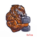 Detail of muscle tiger embroidery patch with dumbbell training design for DIY projects - 6x7cm