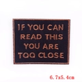 Detail of embroidered patch showing IF YOU CAN READ THIS YOU ARE TOO CLOSE text - You Are Too Close (PE6143CT) / Self-Adhesive