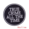 Macro detail of 'True Crime' embroidered patch with black twill base and 7.1cm diameter - True Crime Slogan (PE6235CT)