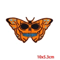 Macro shot of skull butterfly embroidery patch with orange wings and size detail - Orange Butterfly Skull (PE6708CT)