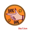Orange cartoon embroidered patch featuring Bang Bang hand gesture and 7.5cm diameter - Bang Bang Orange Hand Gesture Style (PE7681CT)