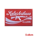 Detail of red embroidered Kalashnikova patch with AK-47 silhouette and white wavy lines - Pe8351ct