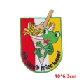 Detail of embroidered frog and fries patch with Dutch text on a tricolor striped base - Frog Hugging Fries Style (PE8543CT)