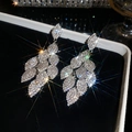 Detailed macro view of silver needle earrings with shimmering leaf-shaped rhinestones. - Overlapping Leaf Style (6#)
