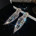 Detailed close-up showing the shimmering rhinestones of long tassel earrings on black velvet - Geometric Rhombus Long Tassel Style (10#)