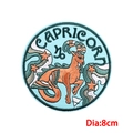 Embroidered Capricorn zodiac patch with orange goat and stars, 8cm circular iron-on badge - Capricorn (PE9125CT)