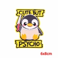 Detail of embroidered penguin patch with Cute But Psycho text and knife in 6x8cm size - Penguin with Knife (PE9239CT)