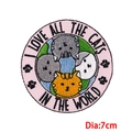 Embroidered 7cm round patch featuring four cartoon cats circling a blue Earth globe - Cats and Globe (PE8779CT)
