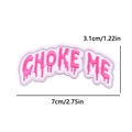 Macro shot of pink CHOKE ME embroidered patch with silver edge and 7x3.1cm dimensions - PE10395CT