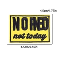 Macro shot of rectangular yellow embroidery patch with black NO RED not today text - Not Today Yellow Patch