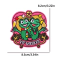 Detailed embroidery patch showing two green frogs with wine glasses on a pink heart base - Frog Holding Cups Heart Style (PE12008CT)