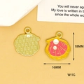 Detail view of pink enamel shell charm with 18mm by 16mm dimensions and gold finish - Shell