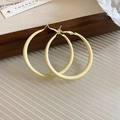 Detailed view of pale yellow C-shaped hoop earrings on a minimalist wooden tray - C-Shaped Hoop Style / Yellow / Large 5cm
