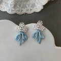 Detailed close-up of light blue ribbon bow earrings with sparkling crystal flowers - Silver Needle / Blue