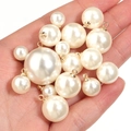 Macro detail of cream pearl pendants with gold metal loops for DIY jewelry making - 6mm / Off White