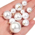 Set of white faux pearl charms with gold metal loops in various sizes shown in hand - 6mm / Pure White
