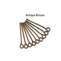 Detailed view of antique bronze eye pins for DIY jewelry making on white background - Bronze