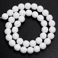 Macro shot of white lava stone round beads with porous texture for DIY jewelry - White / 10mm
