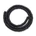 Macro detail of matte black wooden abacus beads arranged in a spiral coil over white background - 10mm / Black
